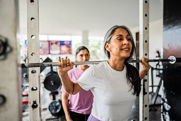 Mature woman doing exercises at gym